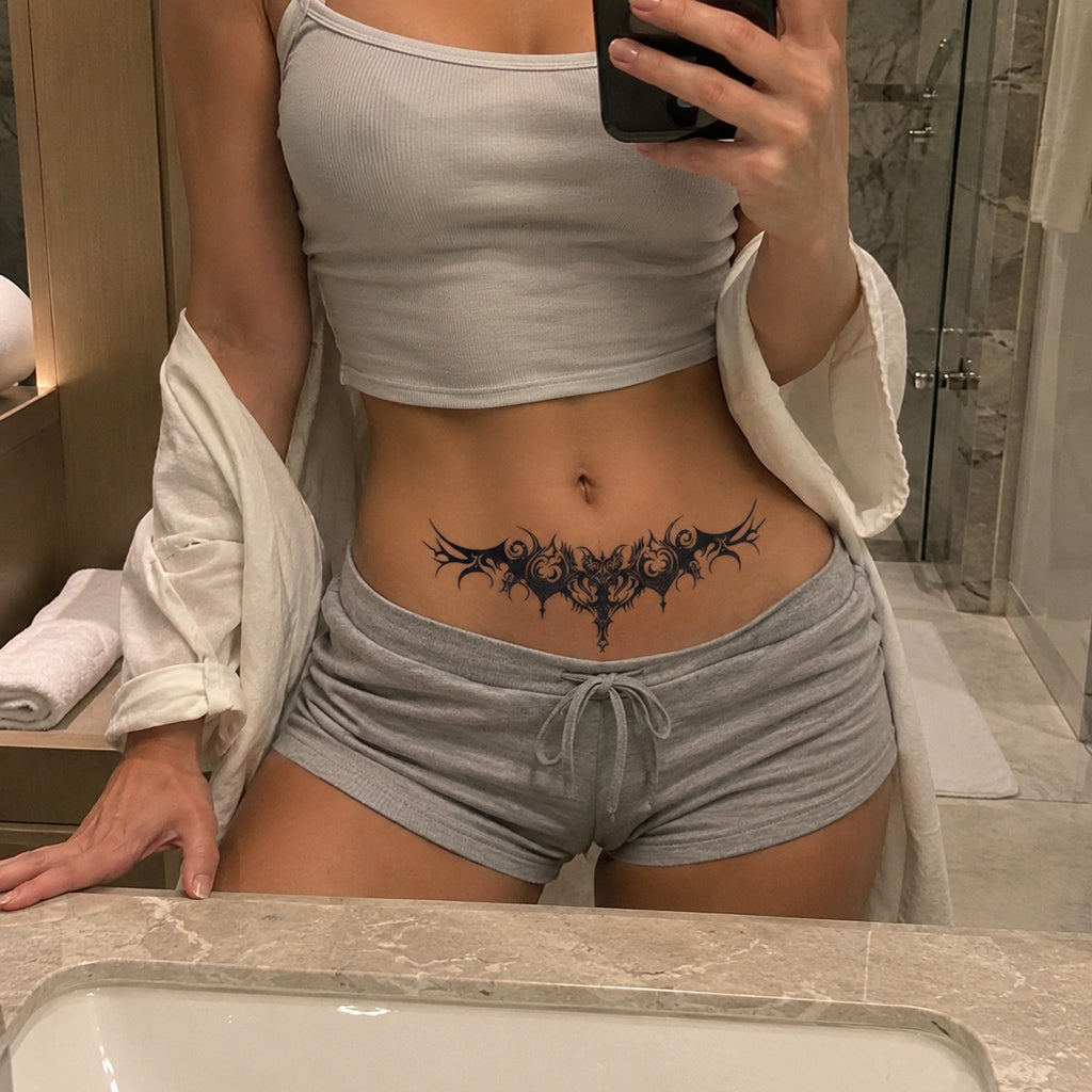 Infernal Crest gothic black temporary tattoo worn on the lower stomach above the waistline
