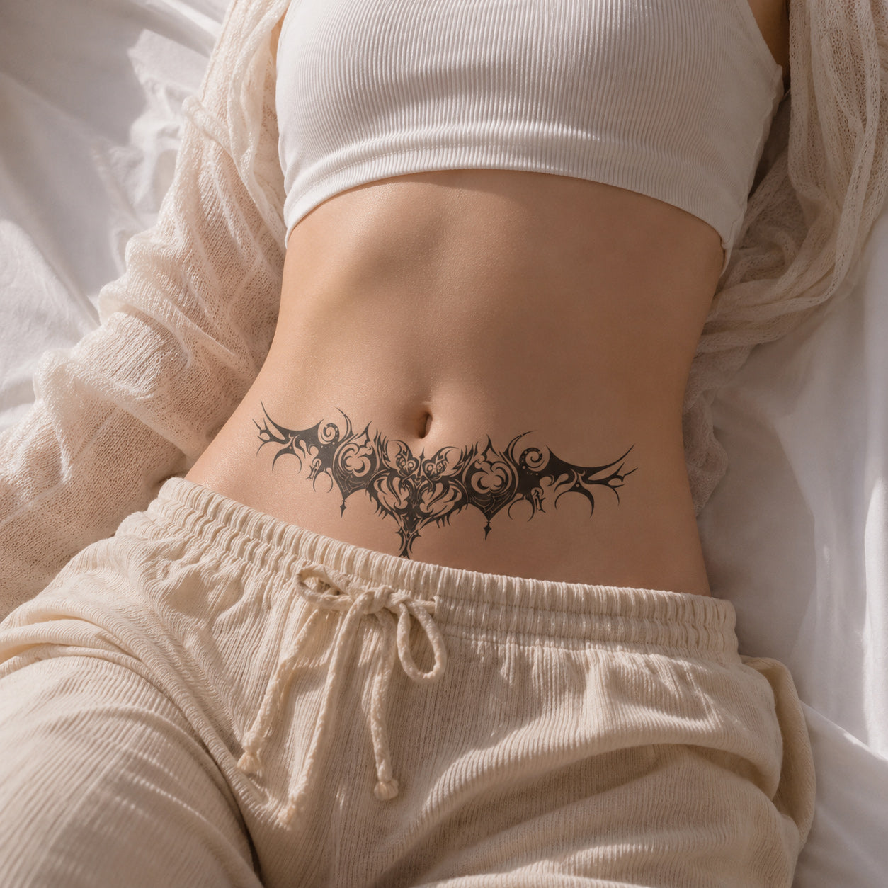 Woman wearing the Infernal Crest succubus temporary tattoo on the lower stomach