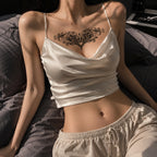 Woman wearing the Midnight Bloom succubus chest temporary tattoo with a satin camisole