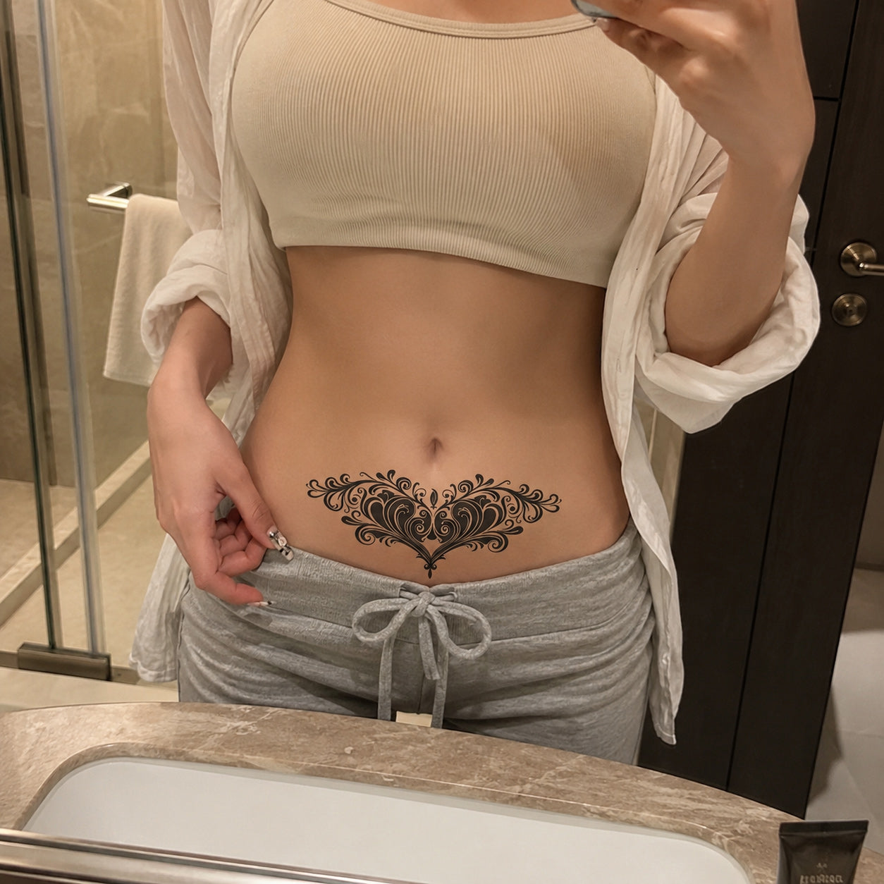 Midnight Bloom gothic floral heart temporary tattoo worn on the lower stomach