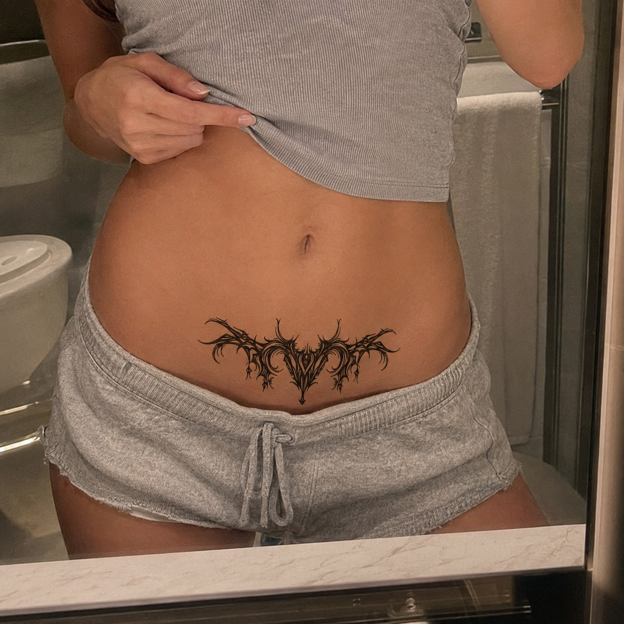 Shadowthorn black gothic temporary tattoo applied above the lower waist