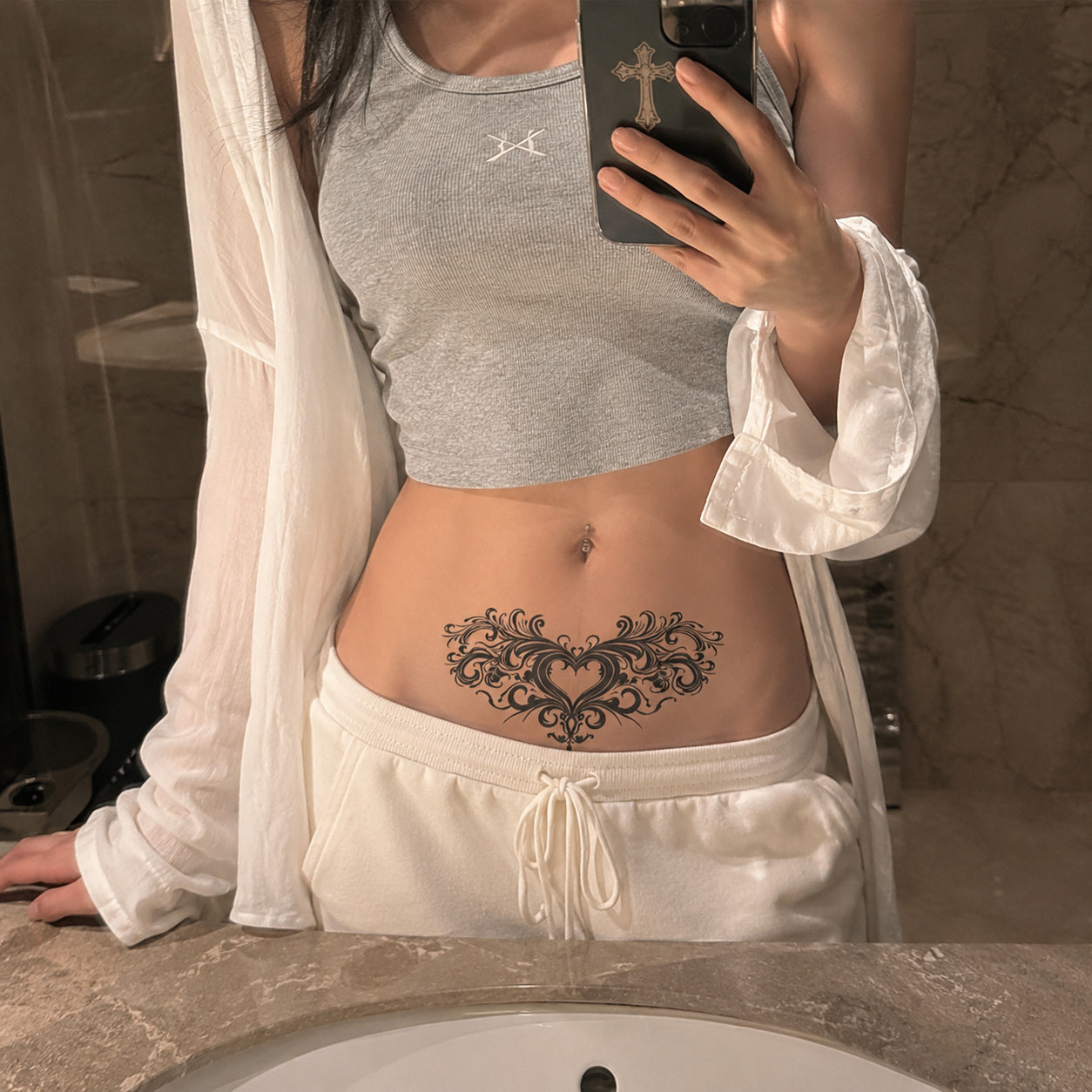 Victorian Heart elegant black temporary tattoo applied across the lower abdomen above the waistline