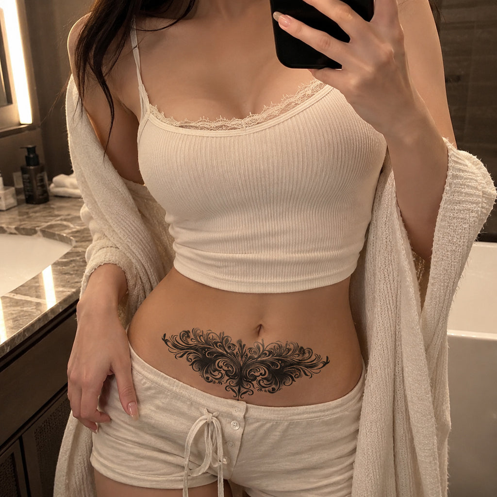 Woman wearing the Baroque Noir elegant black temporary tattoo on the lower stomach