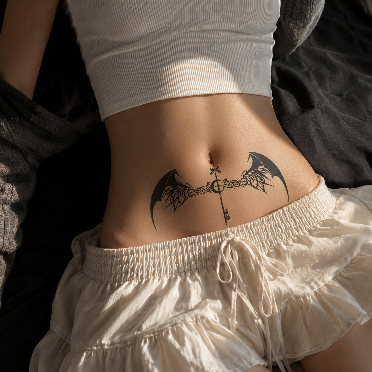 Shadow Key gothic bat wings temporary tattoo centered across the lower abdomen