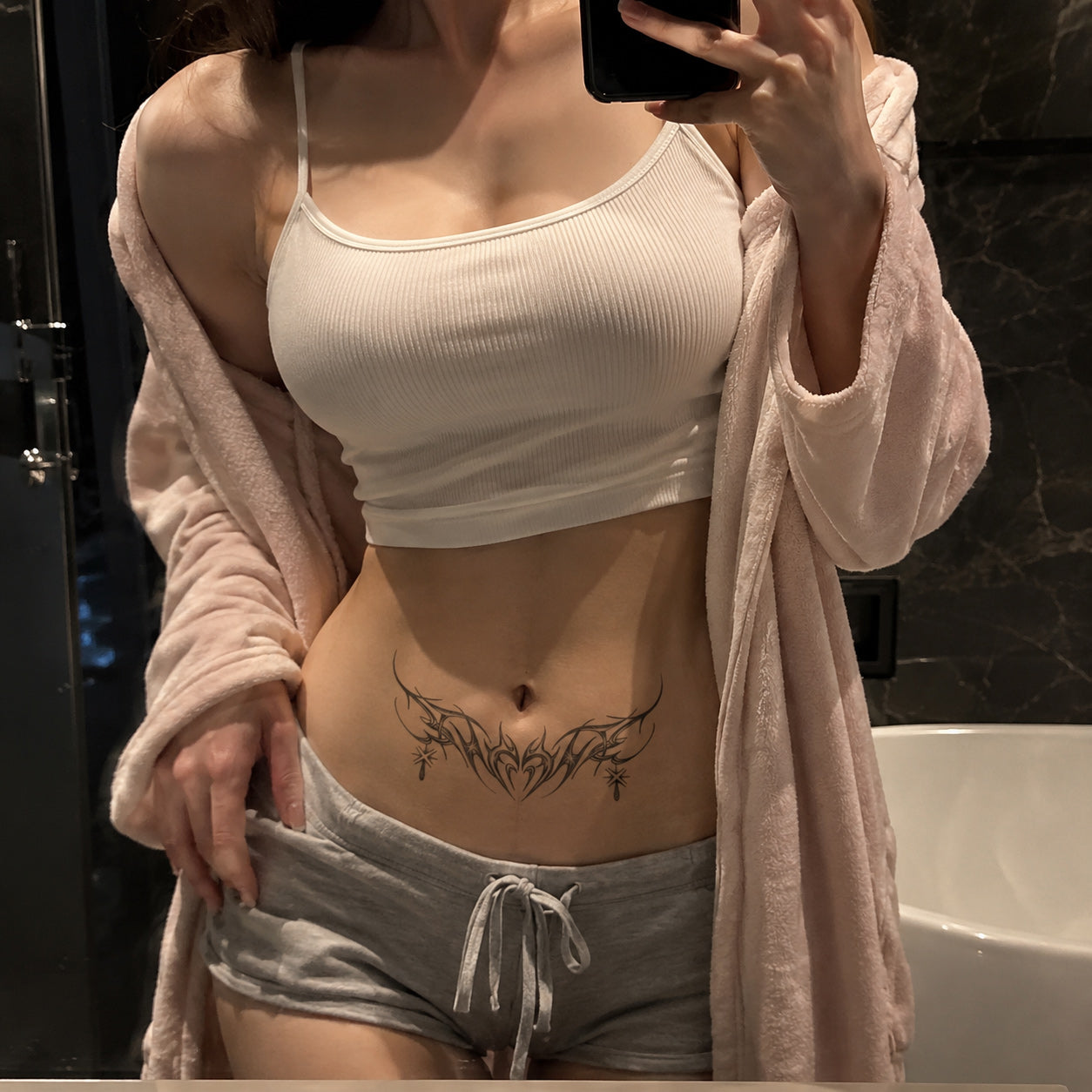 Starlit Thorn gothic tribal temporary tattoo applied across the lower abdomen