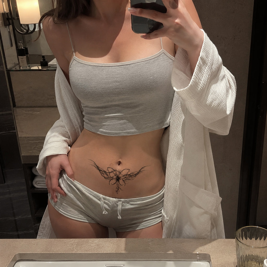 Phantom Bloom abstract butterfly temporary tattoo applied across the lower abdomen