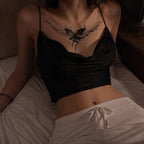 Woman wearing the Ink Veil butterfly temporary tattoo centered across the upper chest