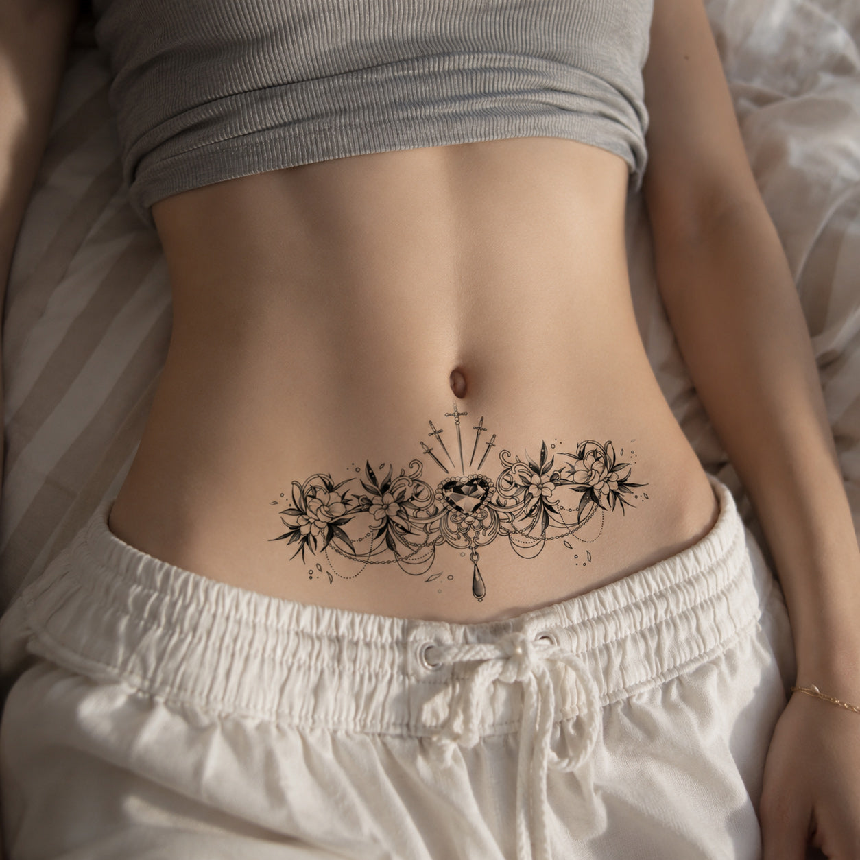 Woman wearing the Sacred Bloom ornamental floral temporary tattoo on the lower abdomen