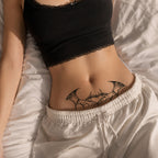 close-up of bat wing heart succubus temporary tattoo on the lower abdomen