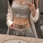 tribal heart temporary tattoo applied above the lower stomach in black gothic style