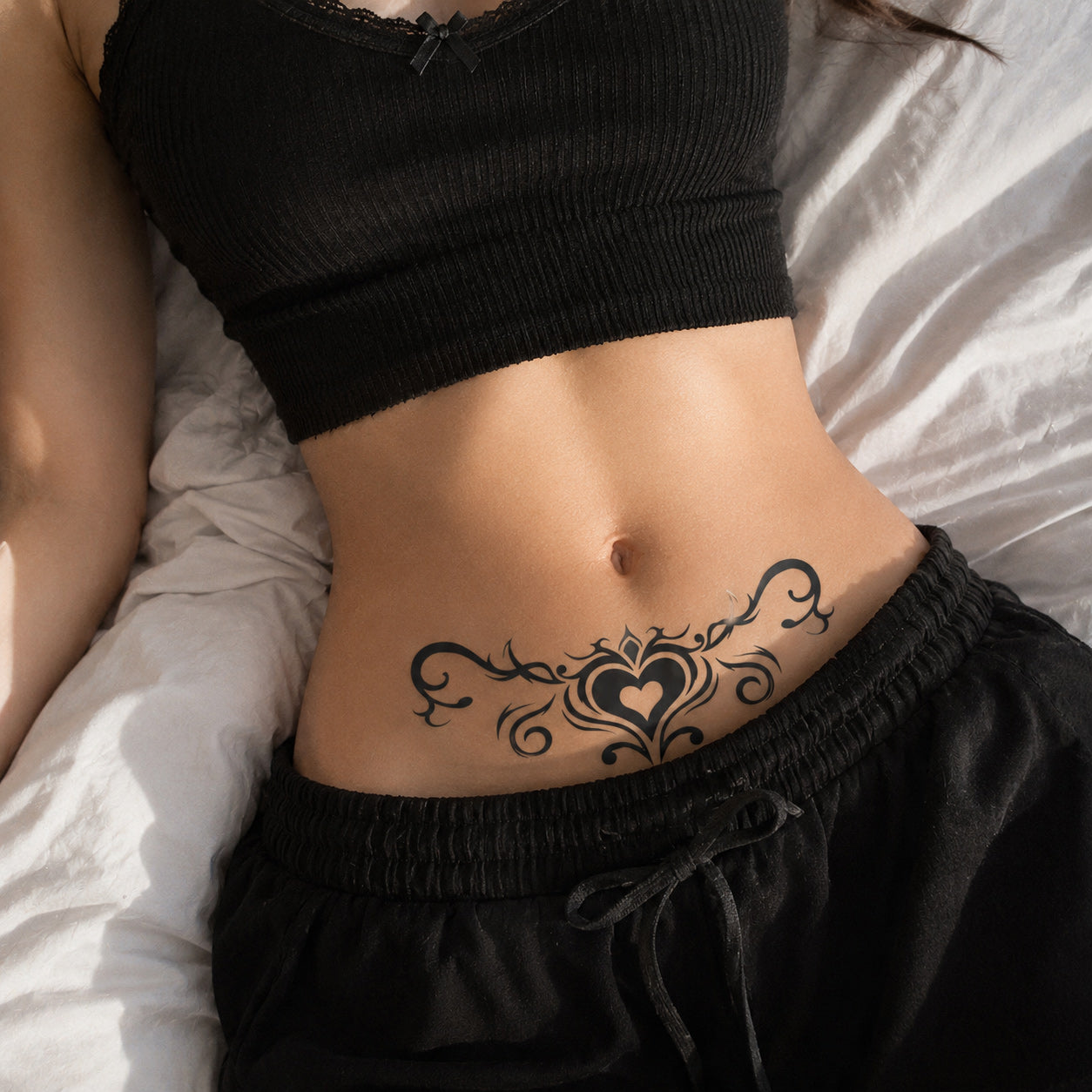 close-up of tribal heart succubus temporary tattoo on the lower abdomen