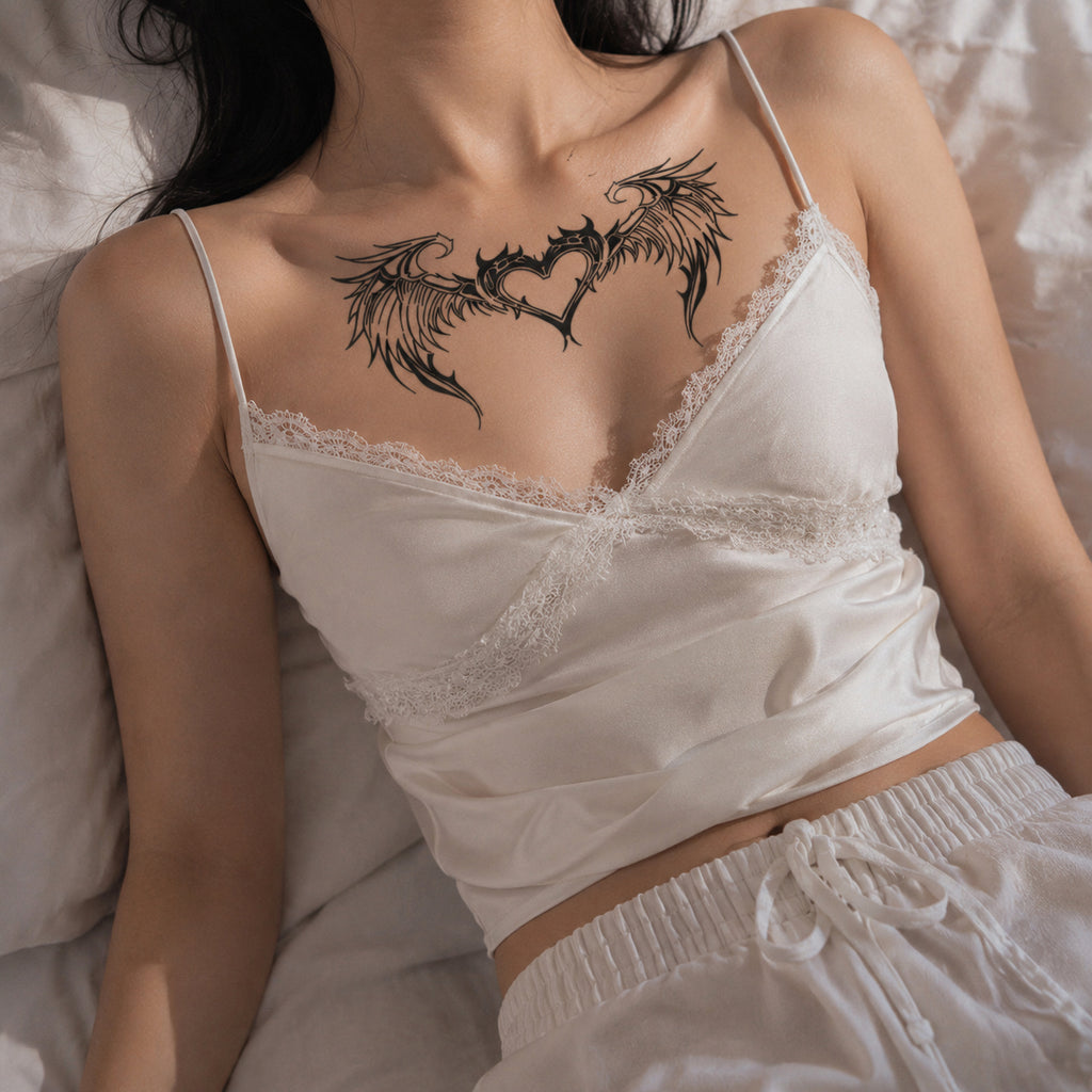 woman wearing celestial wing heart succubus temporary tattoo across the upper chest