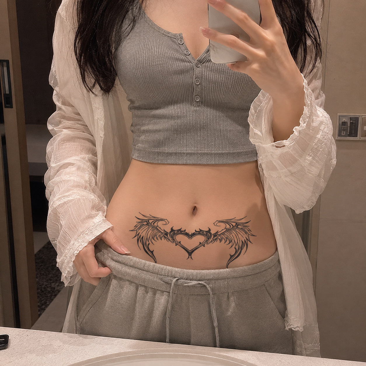 celestial wing heart succubus temporary tattoo placed on the lower stomach