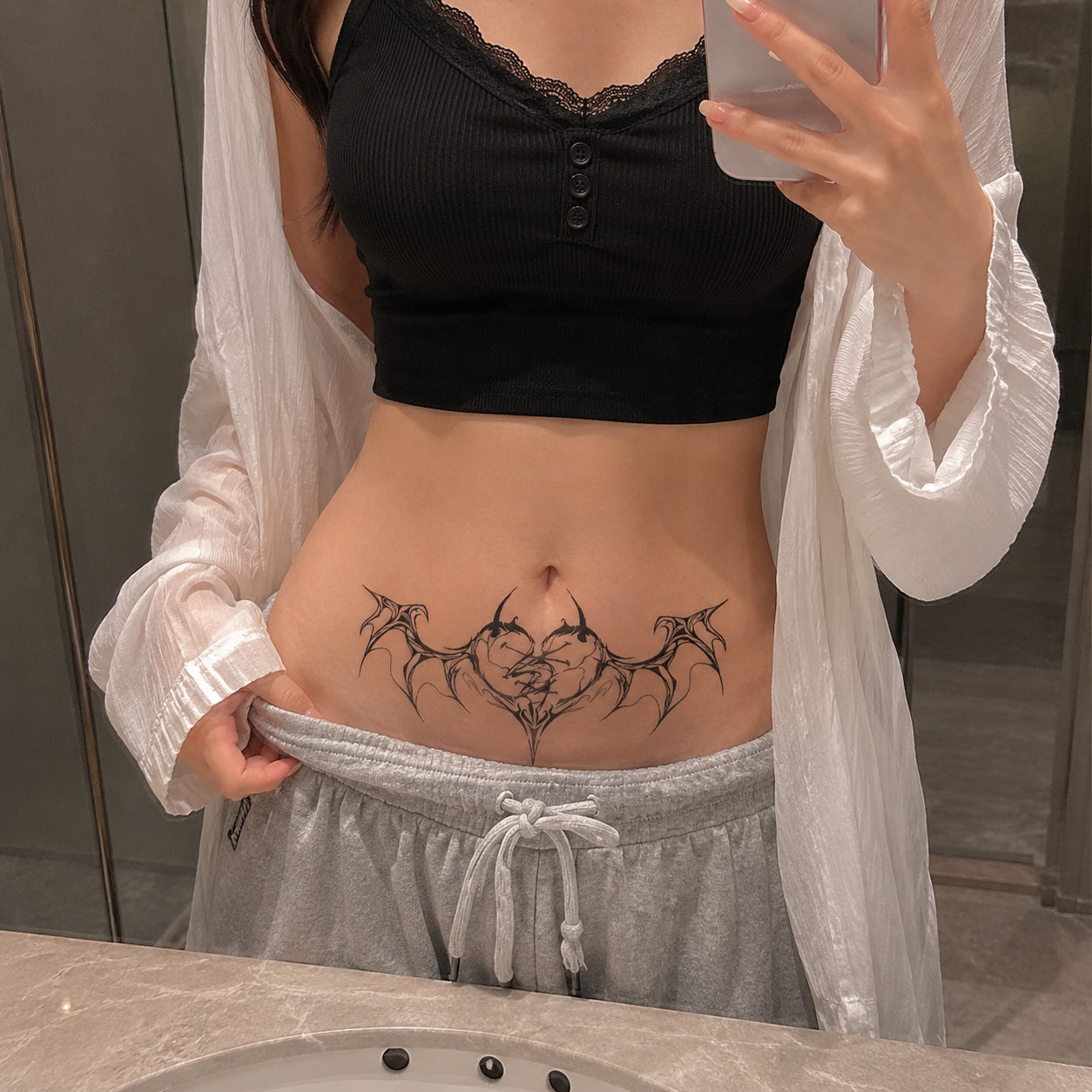 broken heart succubus temporary tattoo placed on the lower stomach above the waistline