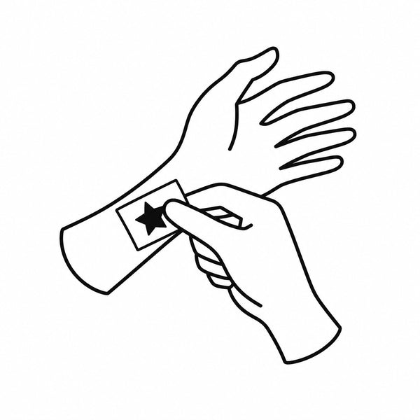 Placing the temporary tattoo sticky side down on clean skin